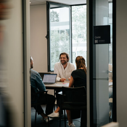 A team of professionals discussing AI-driven solutions in a meeting room.